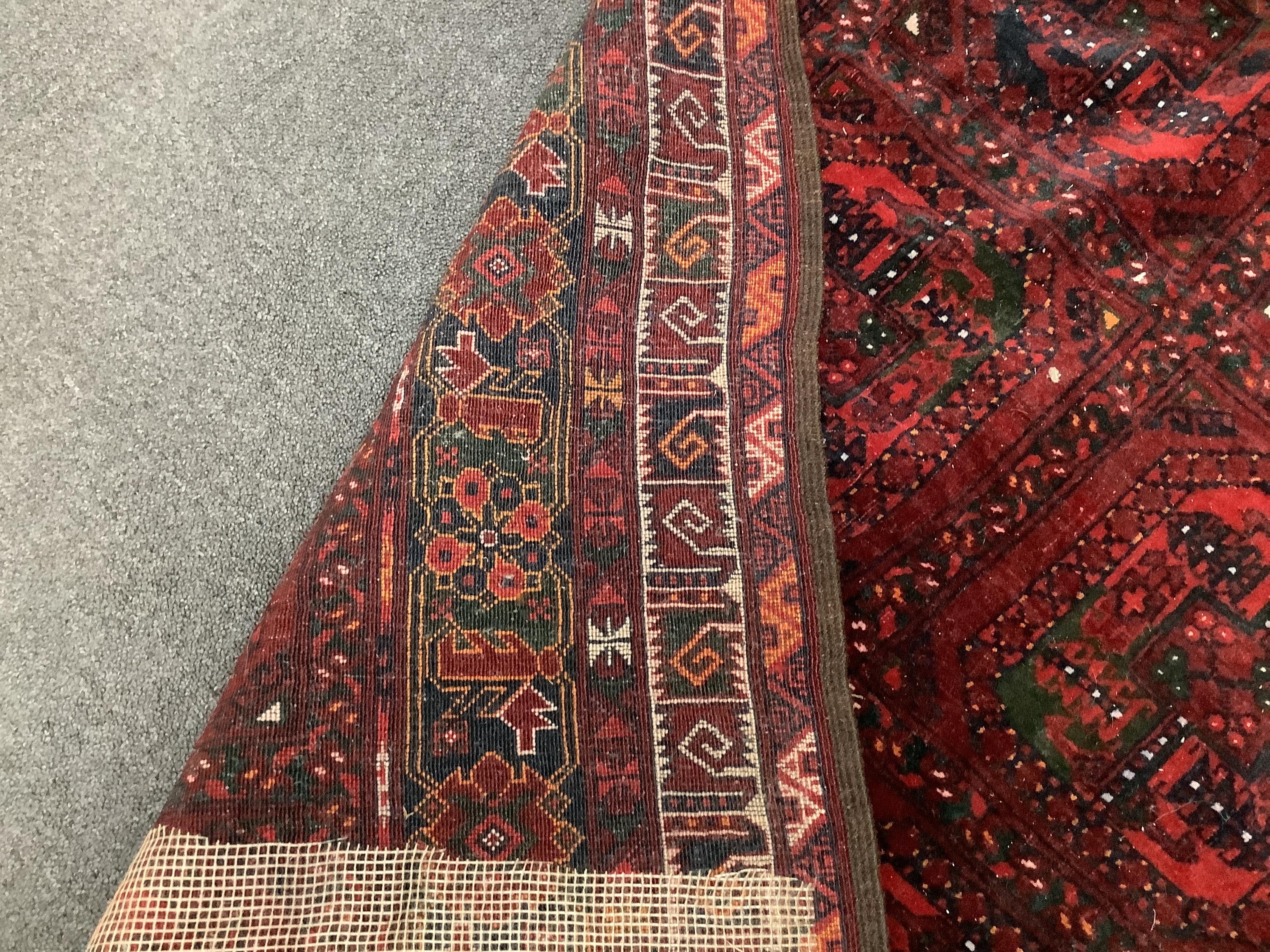 An Afghan red ground rug, 200 x 126cm